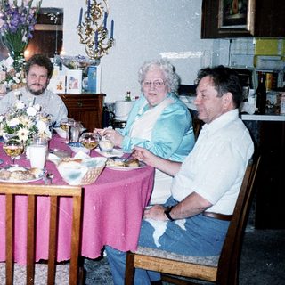Family gathering enjoying meal indoors together.