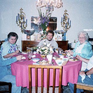 Family gathering enjoying meal indoors together.
