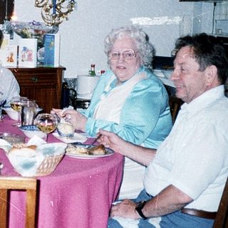 Family gathering enjoying meal indoors together.