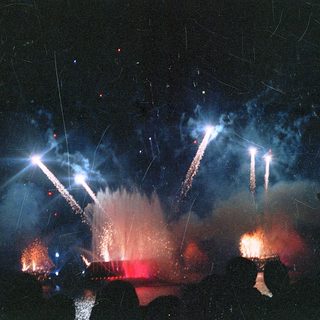Fireworks display illuminating night sky.