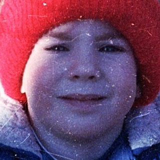 Child playing in snowy outdoor setting.