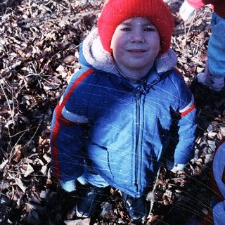 Child playing in snowy outdoor setting.