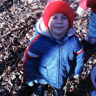 Child playing in snowy outdoor setting.