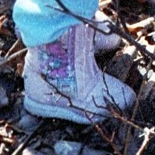 Two children playing outdoors in winter gear.