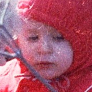 Two children playing outdoors in winter gear.