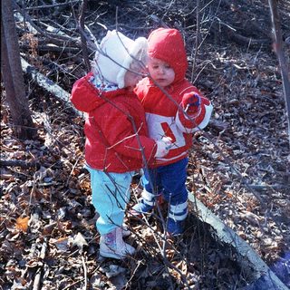 Two children playing outdoors in winter gear.