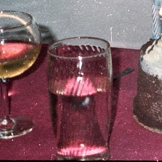 Woman blowing out birthday cake candles indoors.
