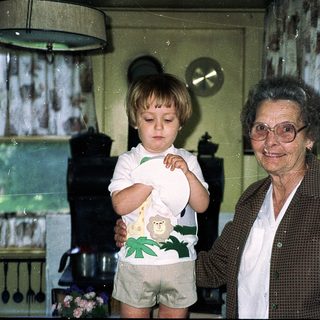 Grandmother and toddler in a cozy kitchen.