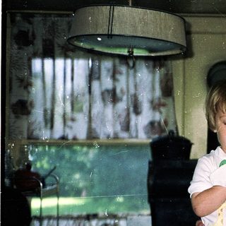 Grandmother and toddler in a cozy kitchen.
