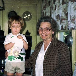 Grandmother and toddler in a cozy kitchen.