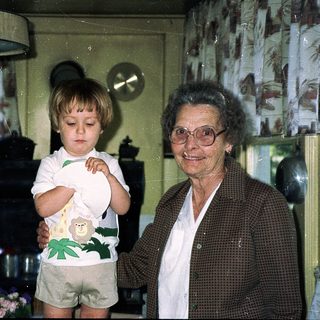 Grandmother and toddler in a cozy kitchen.