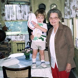 Grandmother and young child in cozy kitchen.
