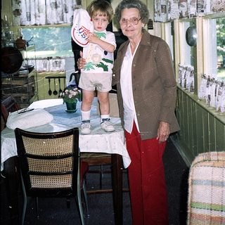 Grandmother and young child in cozy kitchen.
