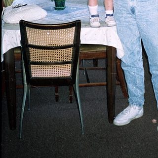Man holding child in vintage London hotel room.