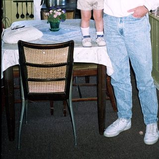 Man holding child in vintage London hotel room.