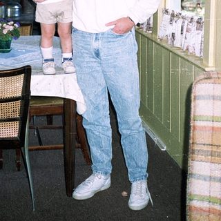 Man holding child in vintage London hotel room.