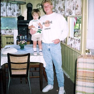 Man holding child in vintage London hotel room.