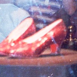Reflection of "Wizard of Oz" ruby slippers display.