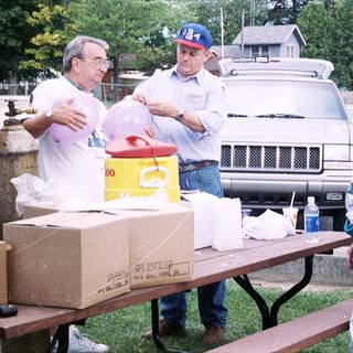 Community volunteers organizing food distribution outdoors.