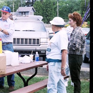 Community volunteers organizing food distribution outdoors.