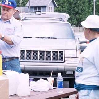 Community volunteers organizing food distribution outdoors.