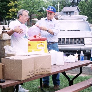 Community volunteers organizing food distribution outdoors.