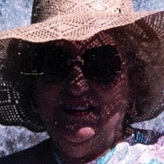 Woman enjoying water fountain show at amusement park.