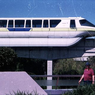 Monorail train at theme park station.