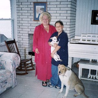 Two people and two dogs indoors.