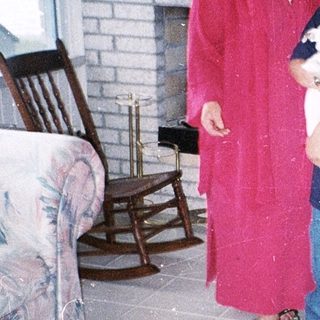 Two people and two dogs indoors.
