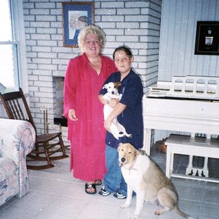 Two people and two dogs indoors.