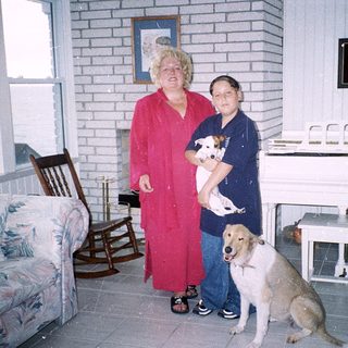 Two women and two dogs indoors.