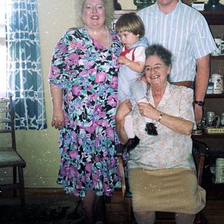 Family portrait in vintage kitchen setting.