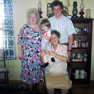 Family portrait in vintage kitchen setting.