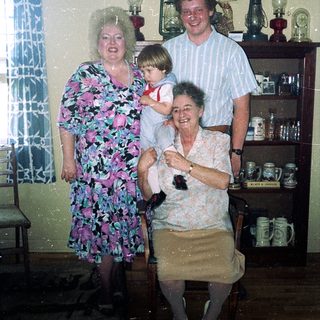 Family portrait in vintage kitchen setting.