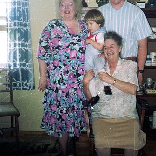 Family gathering in vintage kitchen setting.