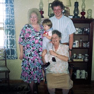 Family gathering in vintage kitchen setting.