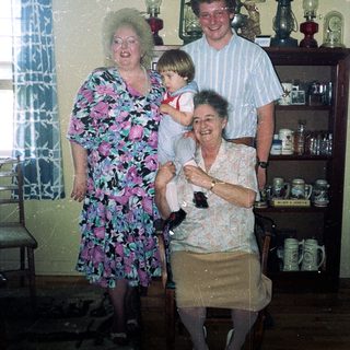 Family gathering in vintage kitchen setting.