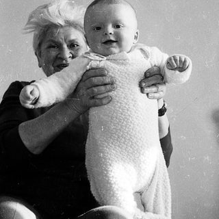 A woman holding a smiling baby.