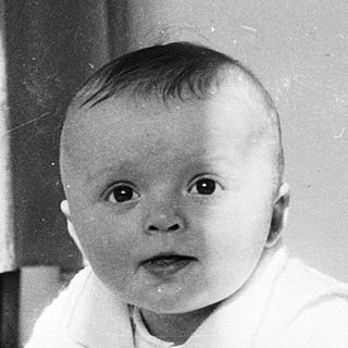 Baby crawling on soft surface indoors.
