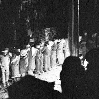 People gathered in a chaotic nighttime protest scene.