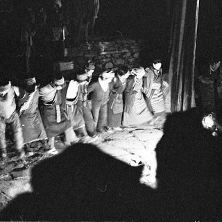 Traditional nighttime festival procession with torches.