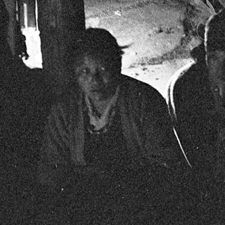 Dark room with person holding glowing cat.
