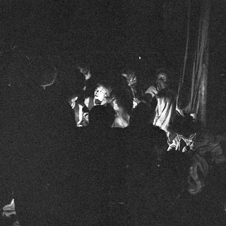 Dancers performing in dimly lit stage.