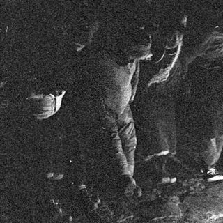 Dark silhouette of a person sitting in a cave.