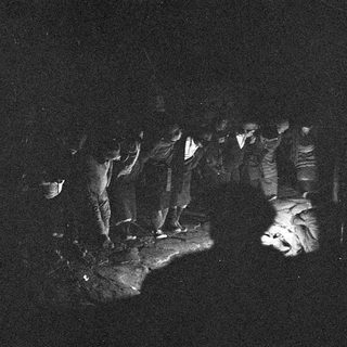 Dark silhouette of a person sitting in a cave.