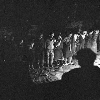Group gathered around nighttime ritual or ceremony.