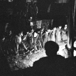Traditional nighttime festival procession with lanterns and banners.