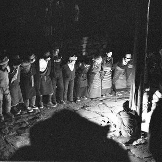 Group gathered around ritual fire ceremony.