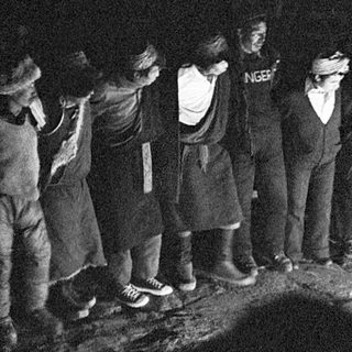 Group gathered around ritual fire ceremony.